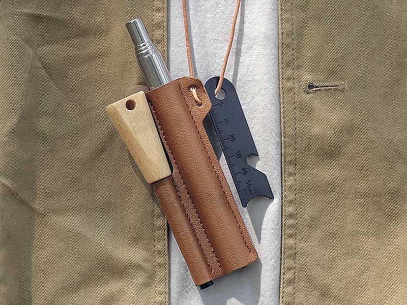 Neck Carry View of The Magnesium Fire Starting Rod with Black Striker Steel and Telescopic Blower in a Faux Leather Sheath