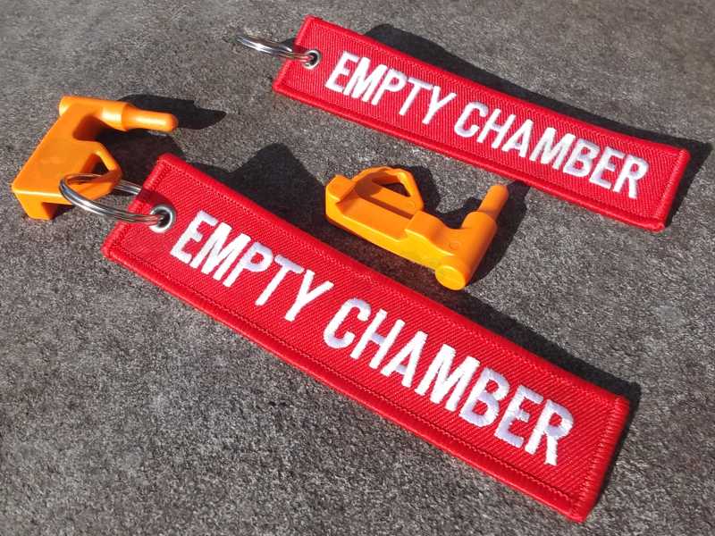 Orange Plastic Empty Gun Chamber Safety Plug Tool Fitted with Red Canvas Flag Keychain with White Embroidered Empty Chamber Text