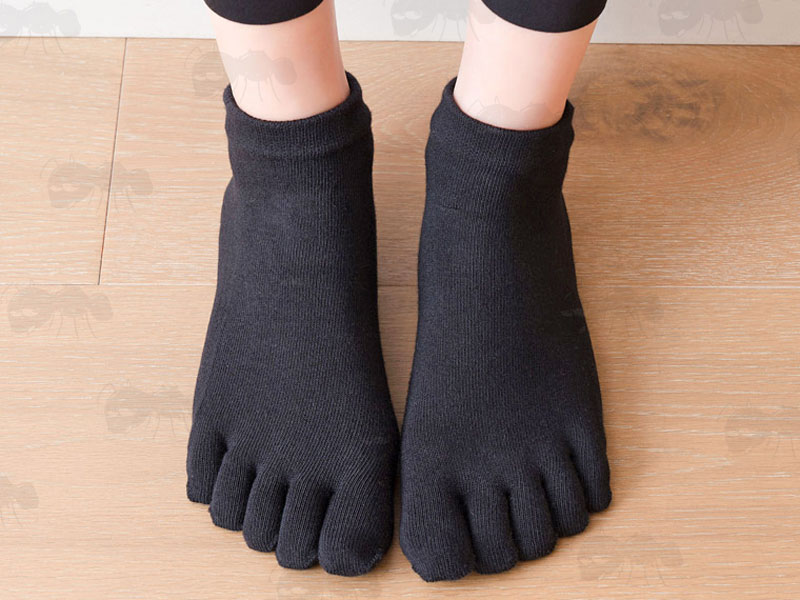 Pair of Black Yoga Non-Slip Toe Socks Being Modelled