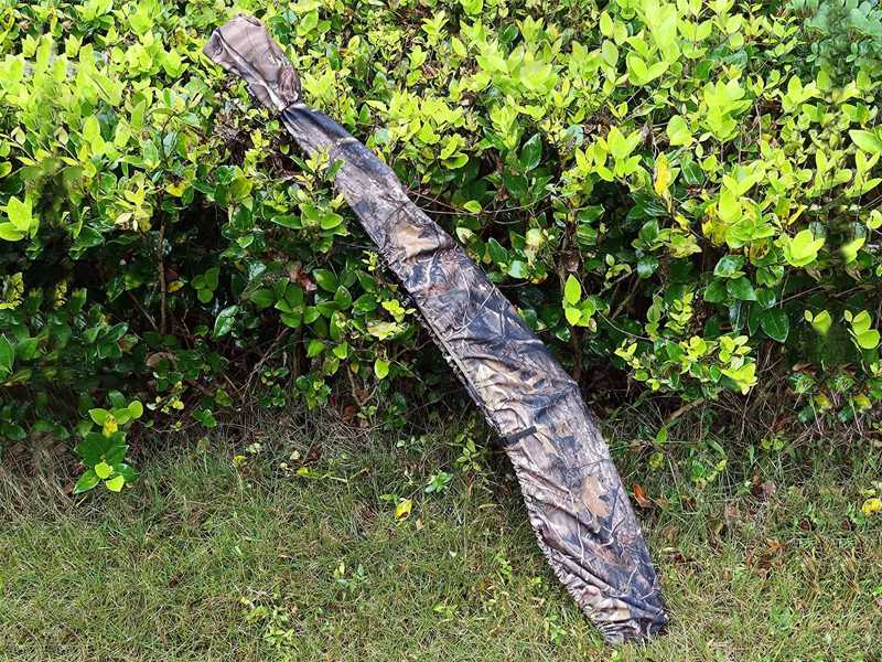 Elasticated Rim Tree Camouflage Patterned Rifle Cover Slip Hood Shown Resting Up Against a Green Hedge