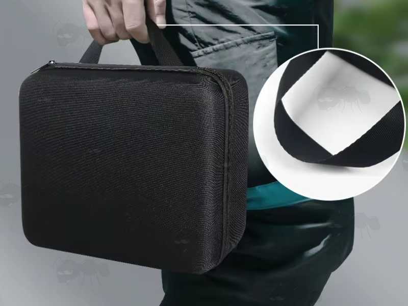 Closed View of A Small Black EVA Rigid Foam Storage Case for Protecting Small Items, Shown Being Carried via The Handle