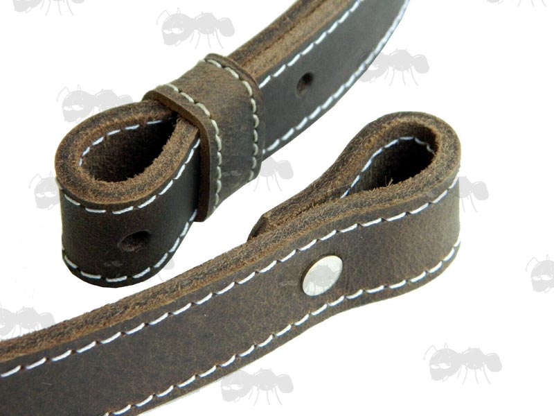 Close-Up View of The Ends of The Thick Dark Brown Leather Gun Sling With White Stitching