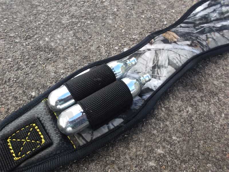 Close-Up View of a 12g CO2 Capsules Attached to The Loop of The Black and Winter Leaf Camouflage Pattern CO2 Air Rifle Sling with Two 12g CO2 Capsule Holder Loops