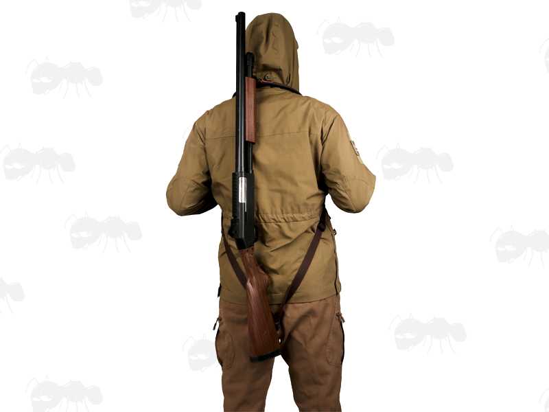 Brown TU Leather and Black Neoprene Padded Hunting Gun Back Harness Sling Fitted with Black Metal QD Swivels and Plastic Side Release Buckles, In Use with Shotgun Being Carried