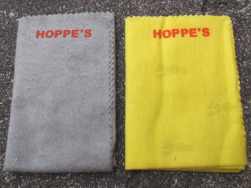Two of Hoppes Gun Cleaning Cloths, One Grey Silicone Treated Cloth and One Yellow Wax Treated Cloth