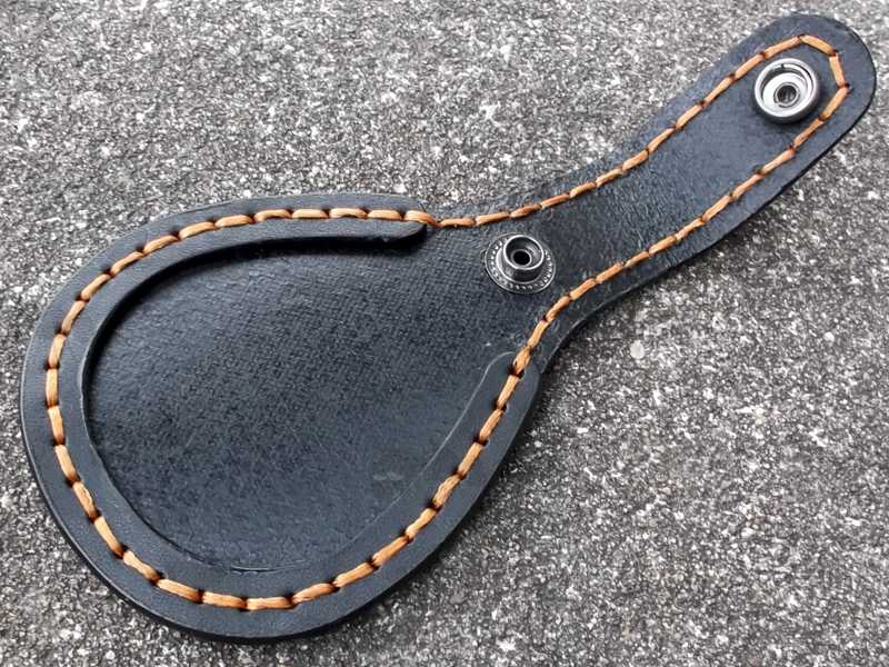 Open View of The AnTac Black Leather Barrel Rest Toe Protector Fitted to a Leather Boot with Brown Stitching