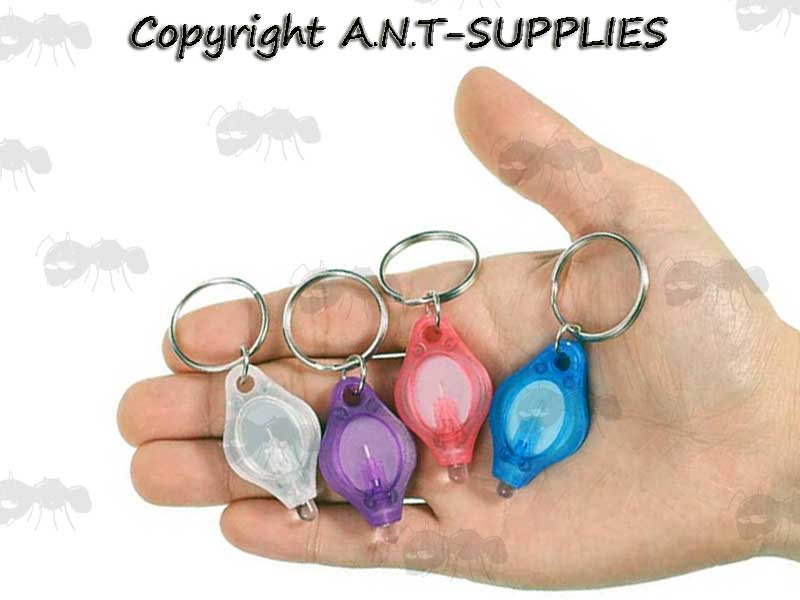 Four Assorted Colour Mini Bright White Keychain Lights with Keyrings in Hand